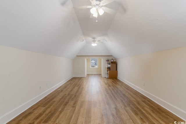 bonus room featuring ceiling fan, lofted ceiling, and light hardwood / wood-style flooring