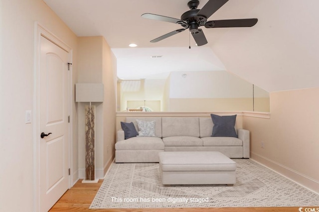 living room featuring lofted ceiling and hardwood / wood-style floors