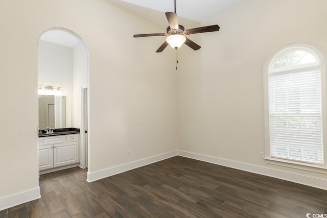 spare room featuring dark hardwood / wood-style flooring, sink, and ceiling fan