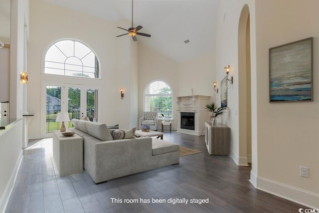 living room featuring ceiling fan, dark wood-type flooring, high vaulted ceiling, and a wealth of natural light