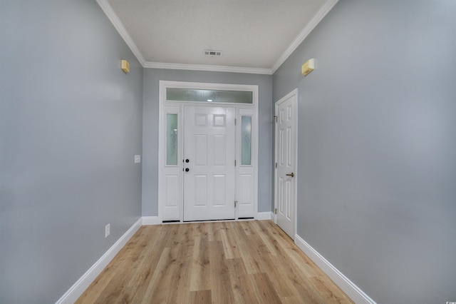 doorway featuring crown molding, a textured ceiling, and light wood-type flooring