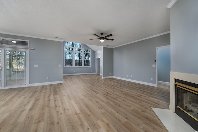 unfurnished living room featuring a textured ceiling, ceiling fan, light hardwood / wood-style floors, and crown molding