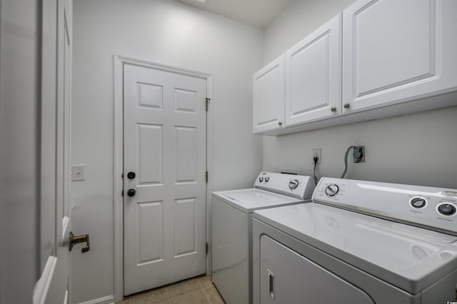 washroom with cabinets, independent washer and dryer, and light tile patterned floors