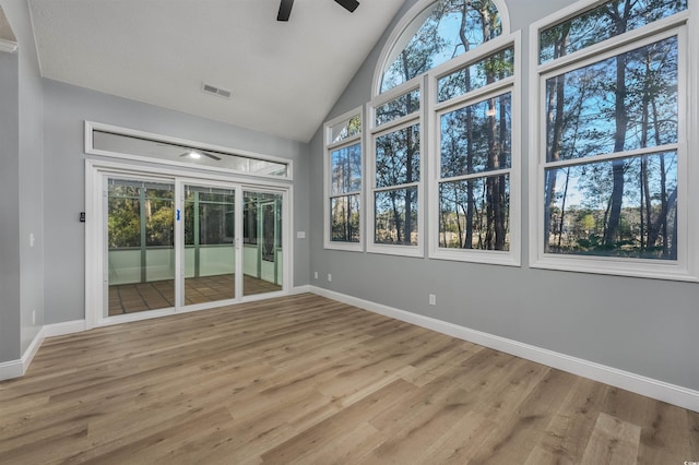 unfurnished sunroom with ceiling fan and lofted ceiling