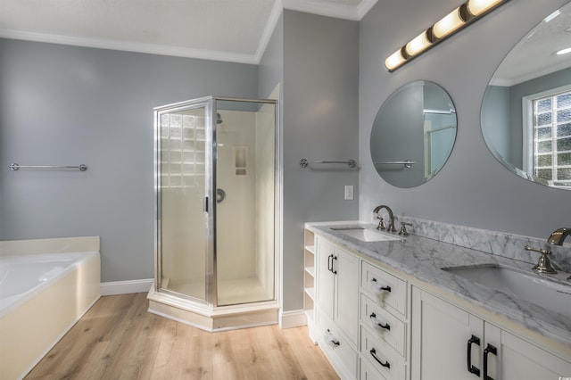 bathroom featuring shower with separate bathtub, vanity, ornamental molding, and wood-type flooring