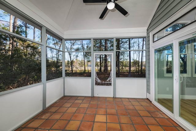 unfurnished sunroom featuring ceiling fan, a healthy amount of sunlight, and vaulted ceiling