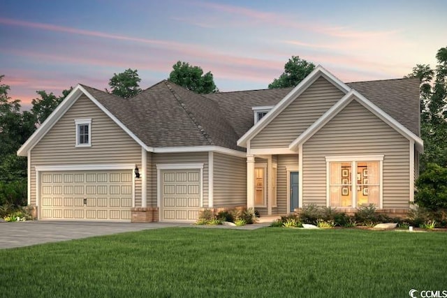 view of front of home with a lawn and a garage