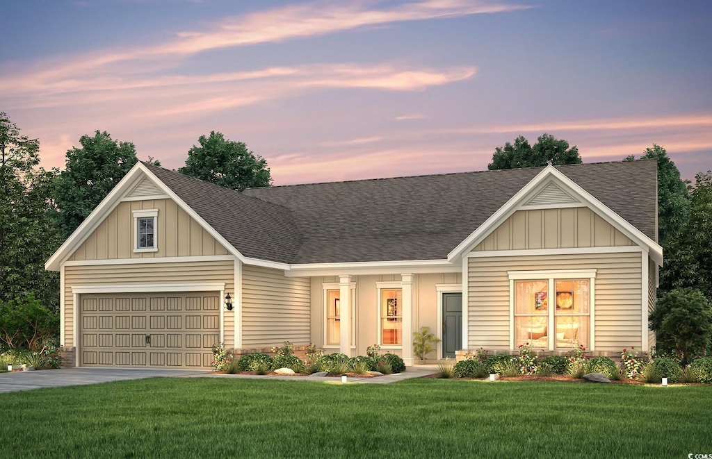 craftsman house featuring a garage and a lawn