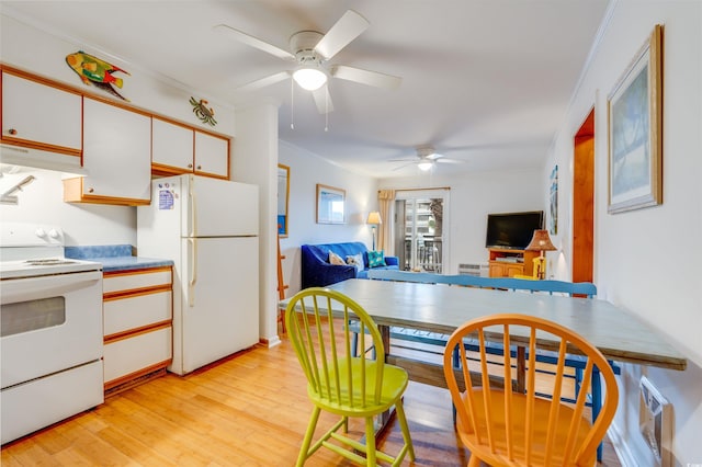 kitchen featuring white cabinets, light wood-style flooring, white appliances, ornamental molding, and extractor fan