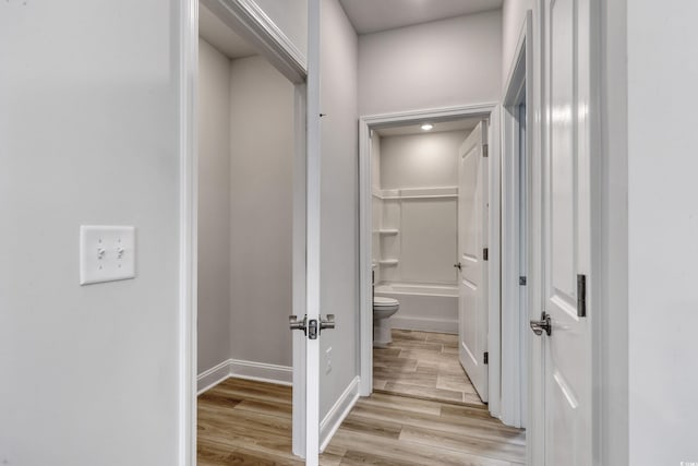 hallway with light hardwood / wood-style flooring