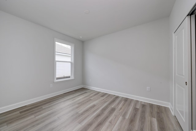 unfurnished bedroom with a closet and light hardwood / wood-style flooring