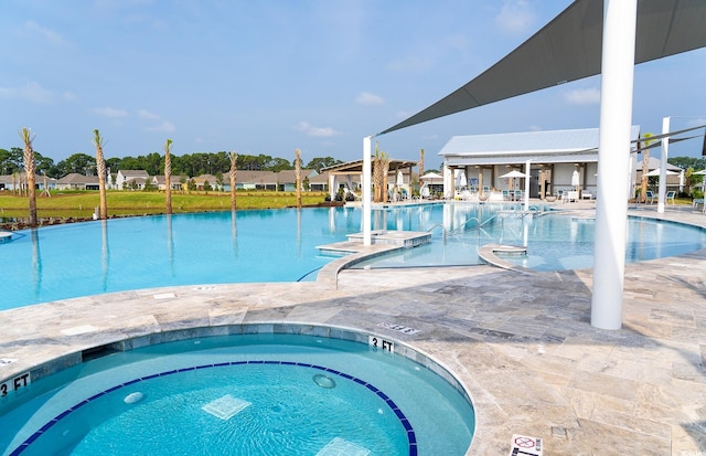 view of swimming pool featuring a hot tub