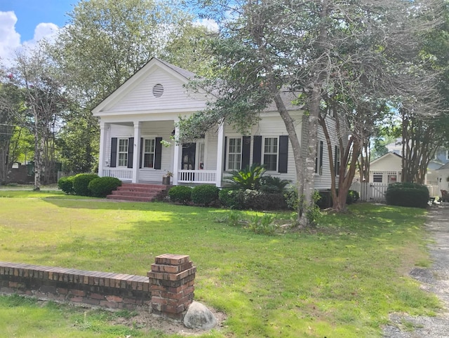 neoclassical / greek revival house with a porch and a front lawn