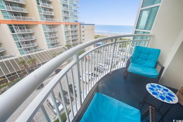 balcony with a water view and a beach view