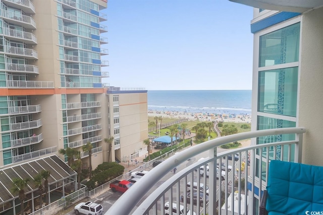 balcony featuring a water view and a view of the beach