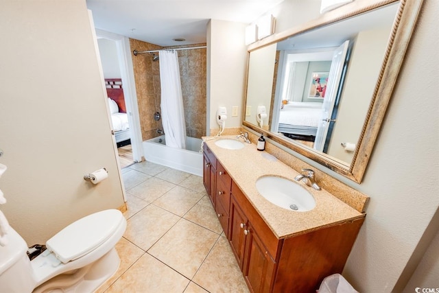 full bathroom with shower / tub combo with curtain, vanity, tile patterned floors, and toilet