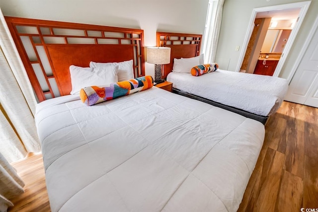 bedroom with wood-type flooring