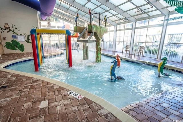 view of pool featuring pool water feature, a lanai, and a playground