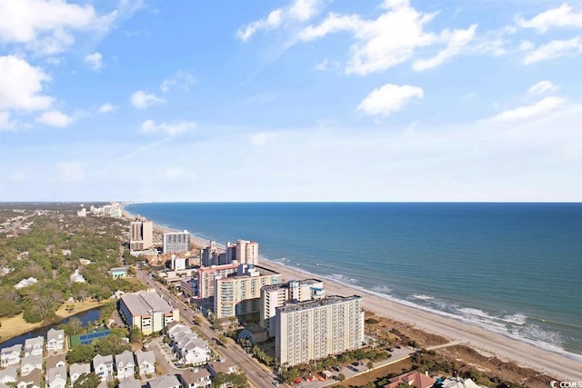 drone / aerial view featuring a beach view and a water view