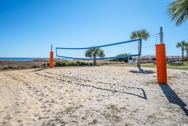 view of property's community with a water view and volleyball court