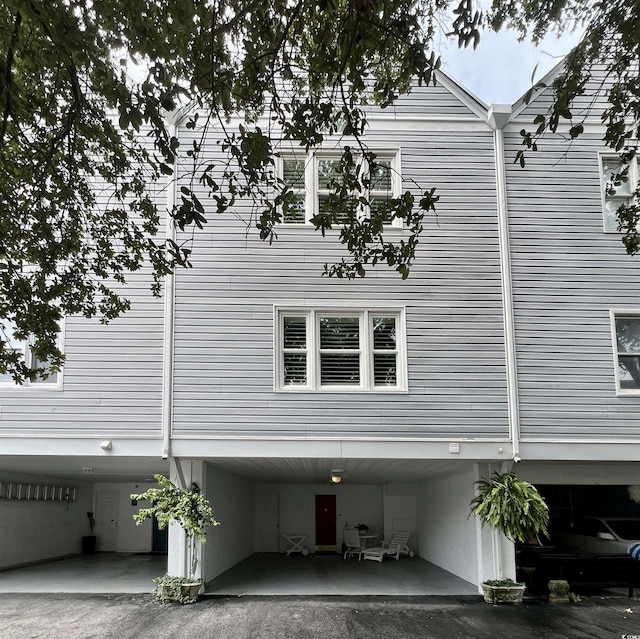 view of side of home featuring a carport and aphalt driveway