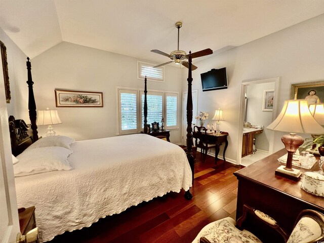 bedroom with lofted ceiling, ceiling fan, ensuite bath, and dark hardwood / wood-style flooring