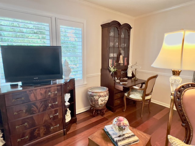 sitting room featuring dark wood-type flooring, plenty of natural light, and crown molding