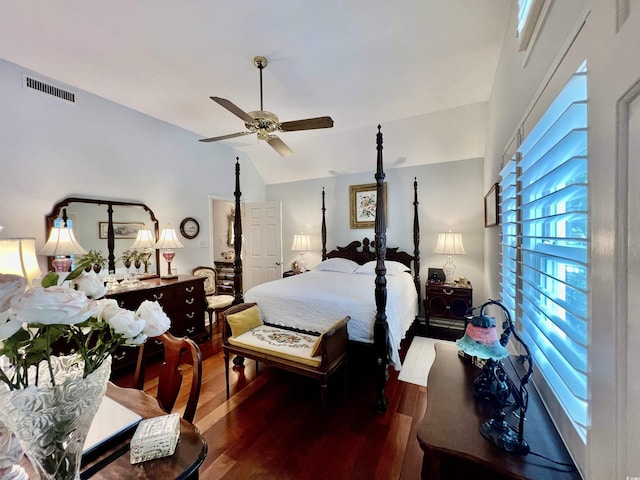 bedroom with lofted ceiling, wood finished floors, visible vents, and a ceiling fan