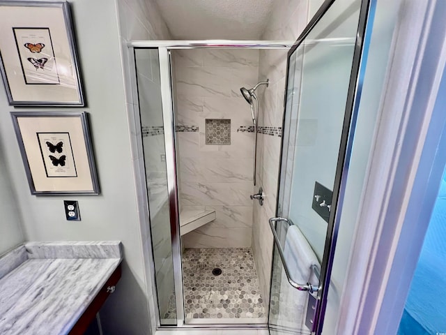 bathroom featuring an enclosed shower and vanity