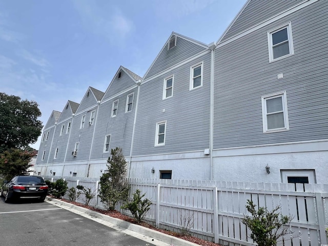 view of home's exterior featuring fence