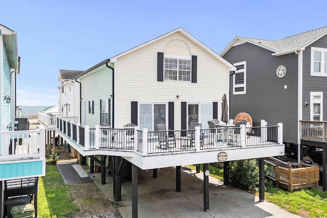 rear view of property with a wooden deck