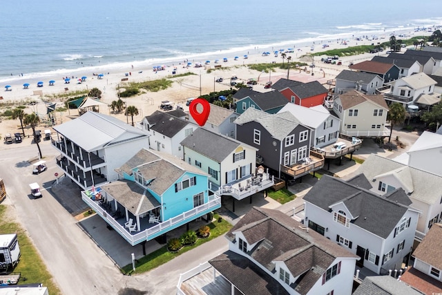 bird's eye view featuring a water view and a beach view