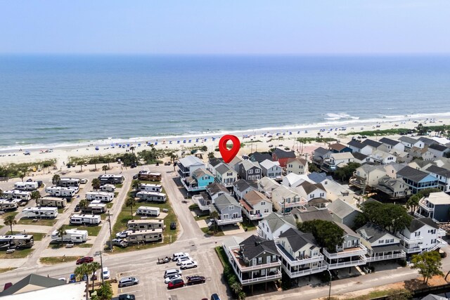 bird's eye view with a water view and a view of the beach