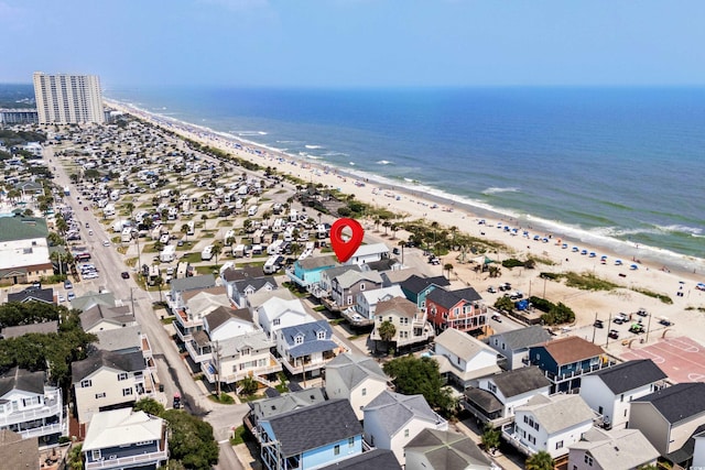 drone / aerial view with a water view and a beach view