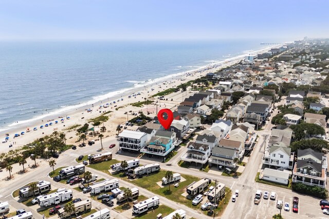 drone / aerial view featuring a water view and a view of the beach