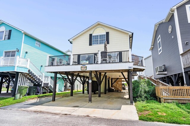 coastal inspired home with a carport and a deck