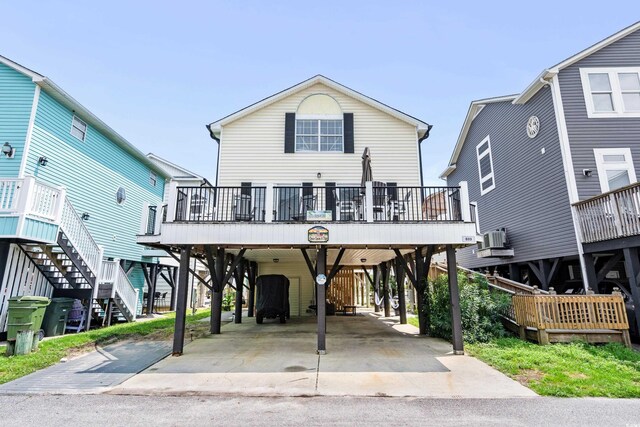 coastal inspired home featuring a carport and cooling unit