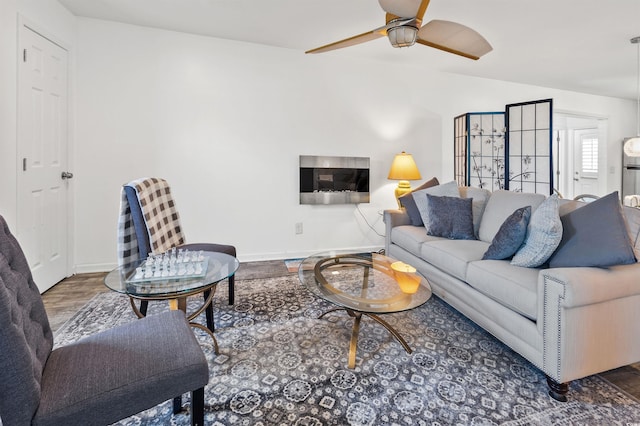 living room featuring hardwood / wood-style floors and ceiling fan