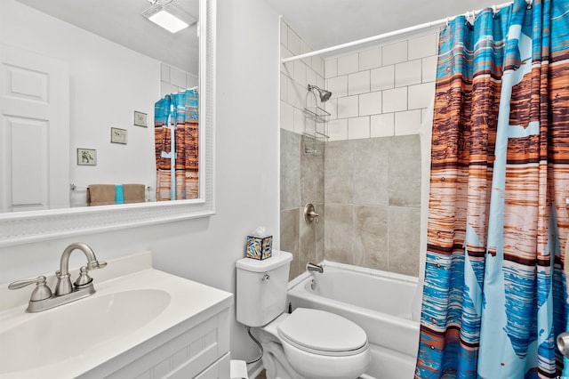 bathroom featuring toilet, shower / tub combo with curtain, and vanity