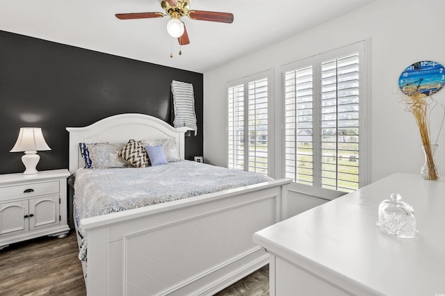 bedroom featuring ceiling fan and dark wood-type flooring