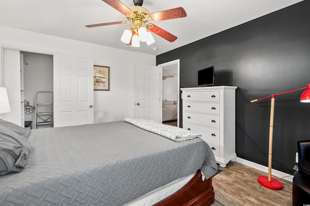 bedroom featuring hardwood / wood-style flooring and ceiling fan