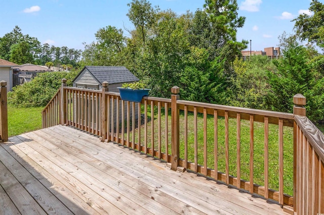 deck with an outdoor structure and a yard