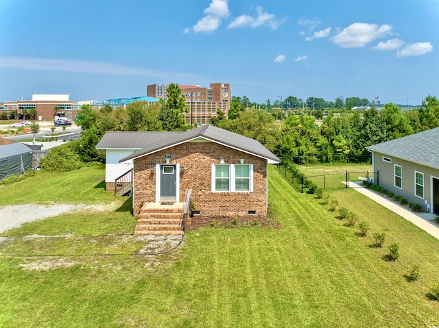 view of front of property with a front yard, crawl space, and fence