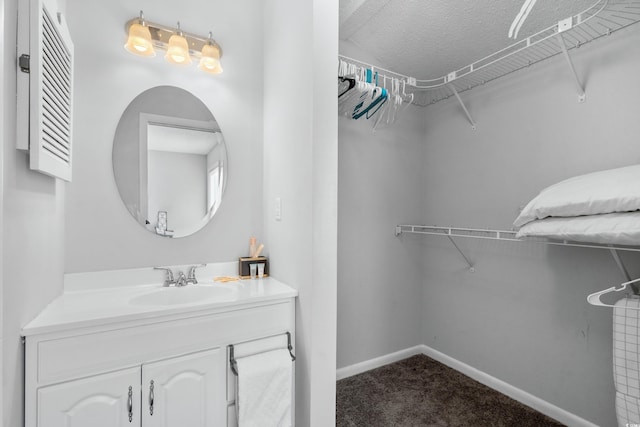 spacious closet with sink and carpet