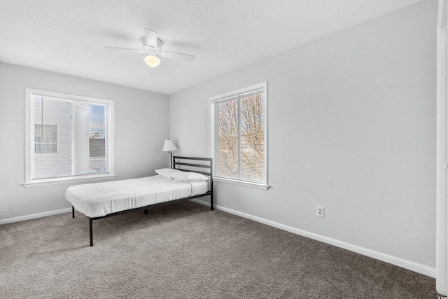 bedroom featuring carpet, a textured ceiling, and ceiling fan