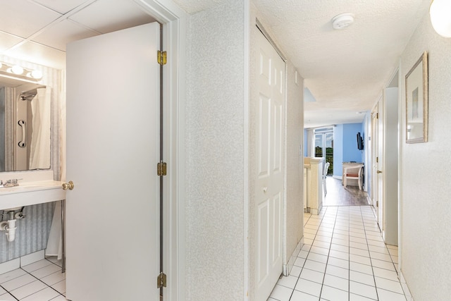 corridor with light tile patterned flooring