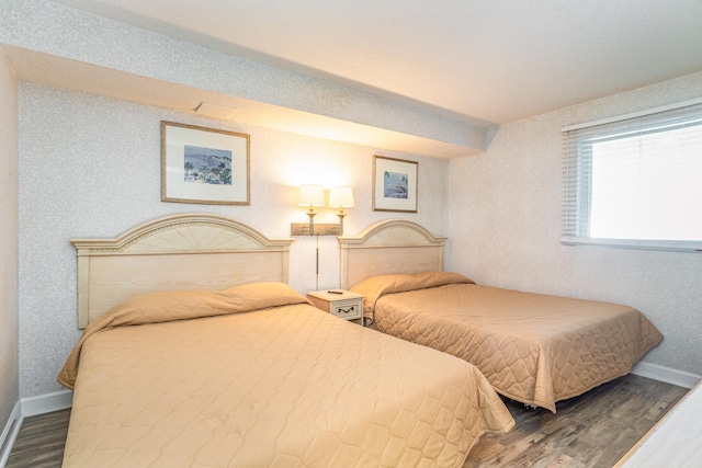 bedroom with dark hardwood / wood-style floors