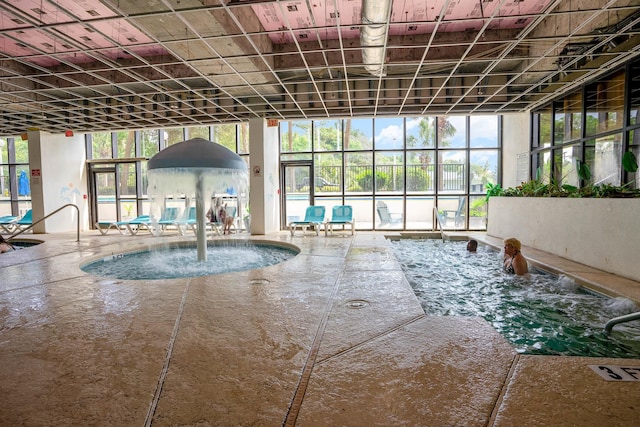 view of swimming pool with pool water feature