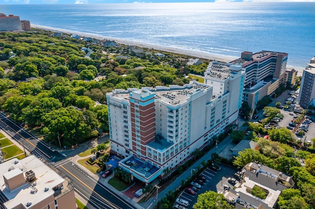 drone / aerial view with a water view and a beach view