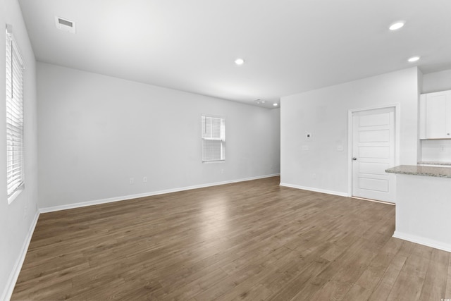 unfurnished living room with dark hardwood / wood-style flooring